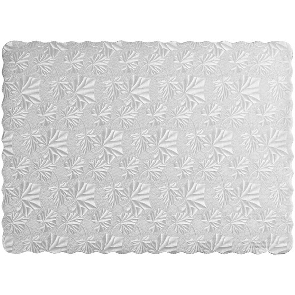 A white rectangular cake board with a pattern of leaves.