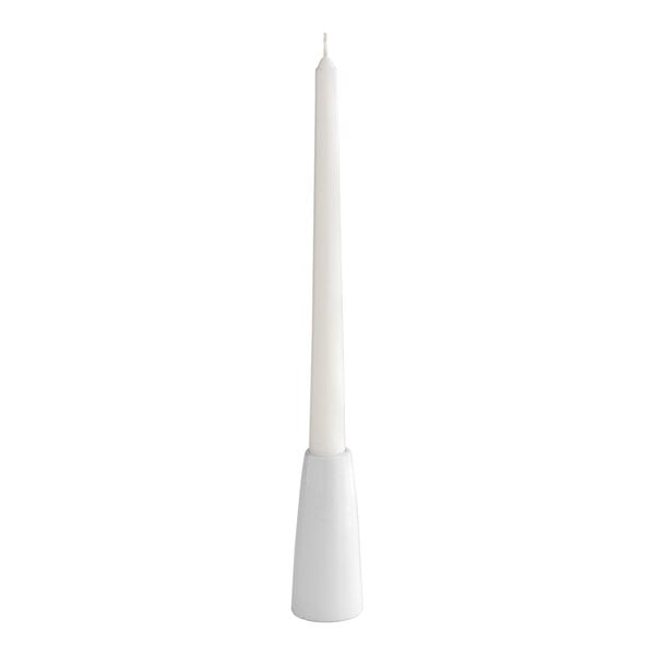 A white porcelain taper candle holder with a tall white taper candle.