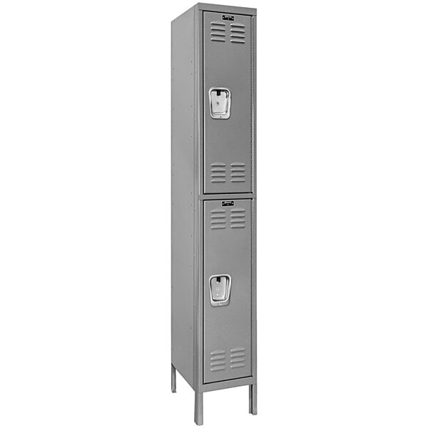 A close-up of a Hallowell gray metal locker with two doors.