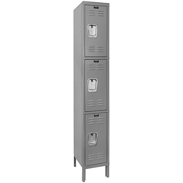 A close-up of a Hallowell gray metal single 3-tier locker with recessed handles.