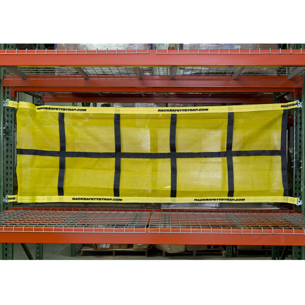 A yellow and black Adrian's Safety Solutions safety net hanging on a pallet rack.