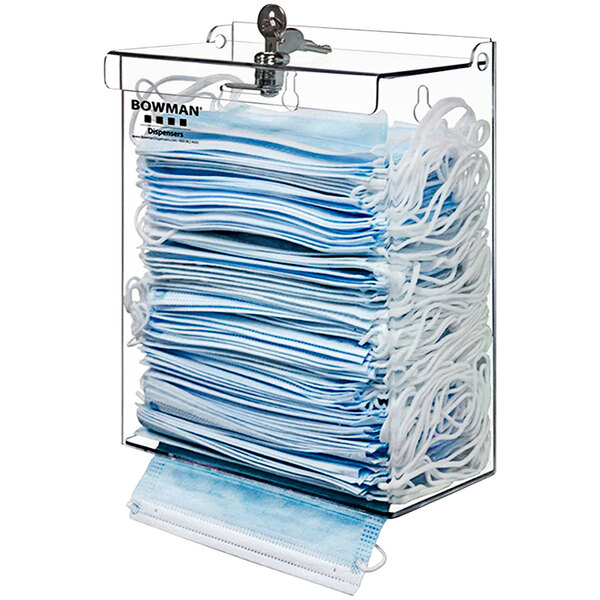 A clear container with a stack of face masks.