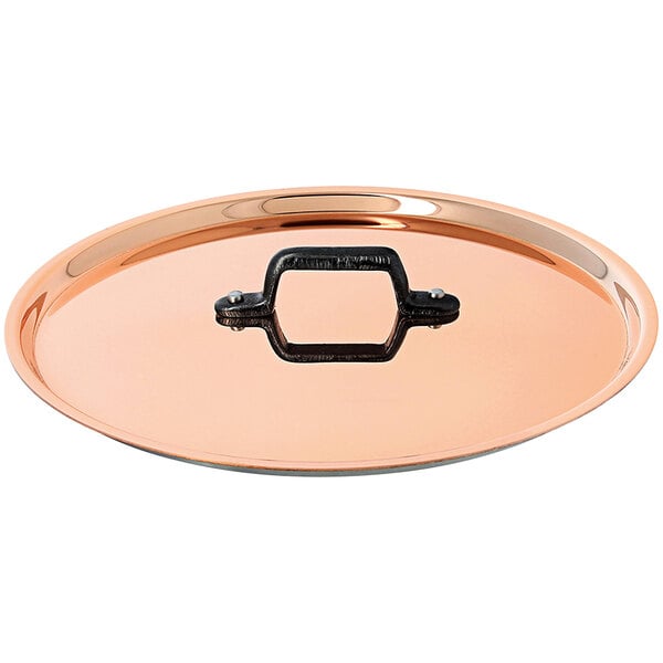 A de Buyer InoCuivre Tradition copper lid with a handle.