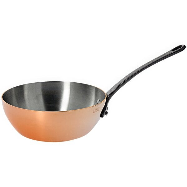 A de Buyer conical copper stir fry pan with a handle.