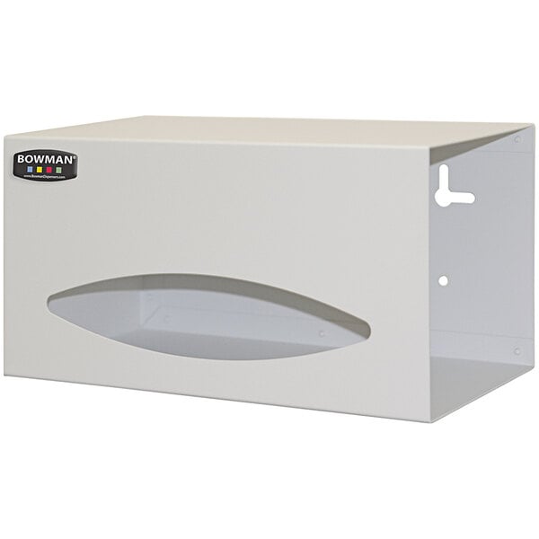 A beige powder-coated aluminum wall mount bag dispenser with a small hole.