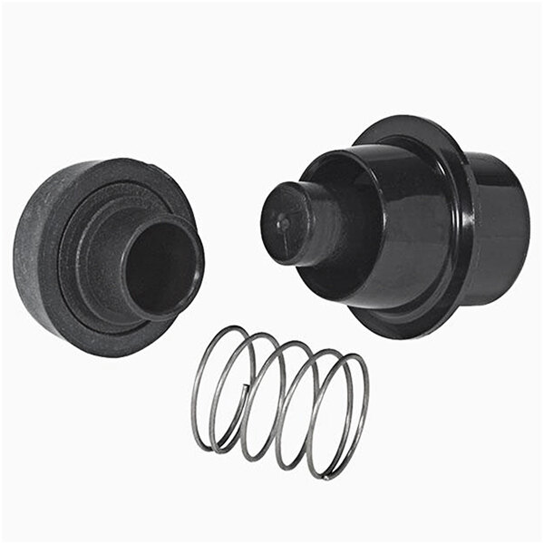 A close-up of a black plastic round object with a hole and a metal spring.