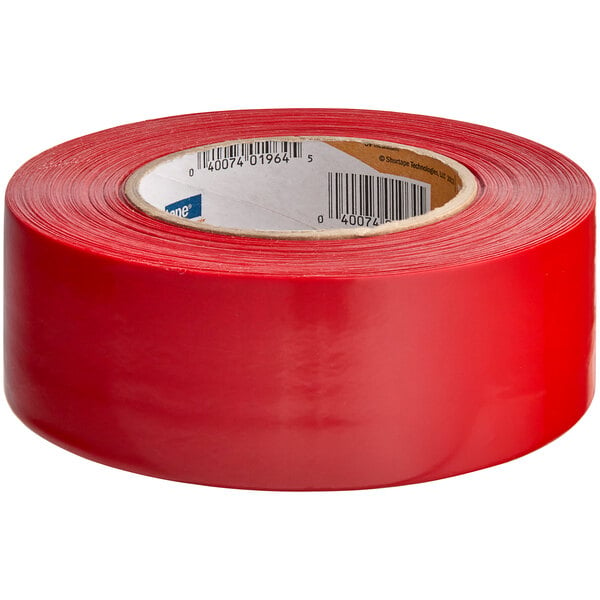 A roll of red Shurtape PE 444 UV-resistant stucco masking tape.