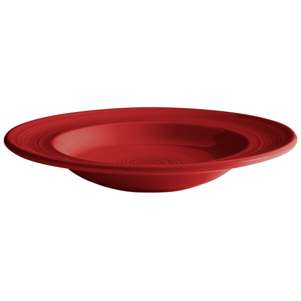 A white background with a red Tuxton Concentrix bowl with a swirl design in the bottom.