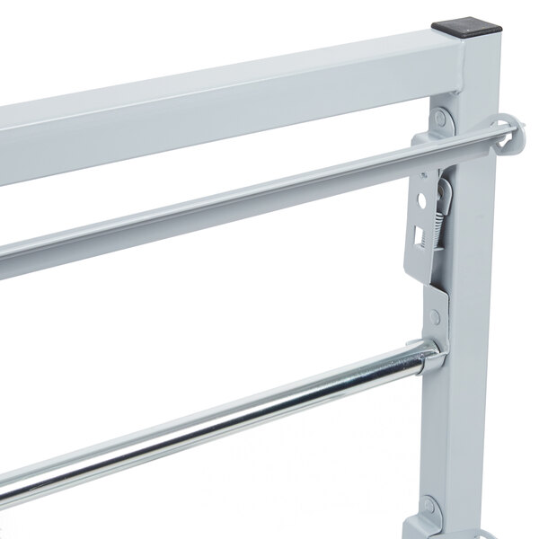 A Bulman metal tower paper rack with two metal bars and a black handle.