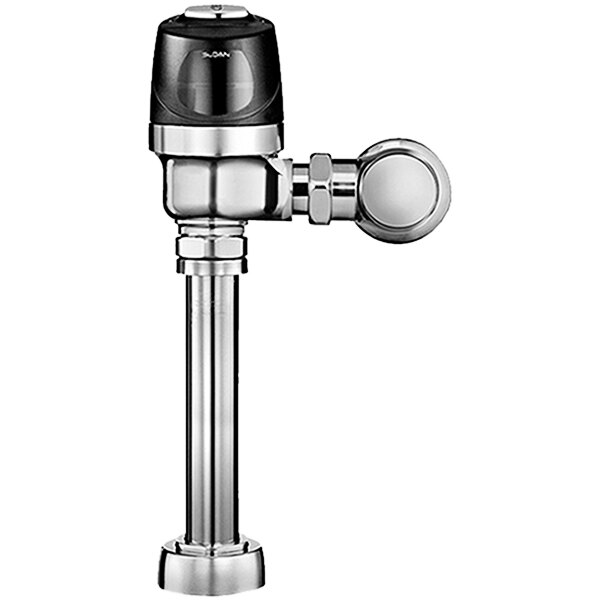 A close-up of a chrome water valve with a black electrical override button.