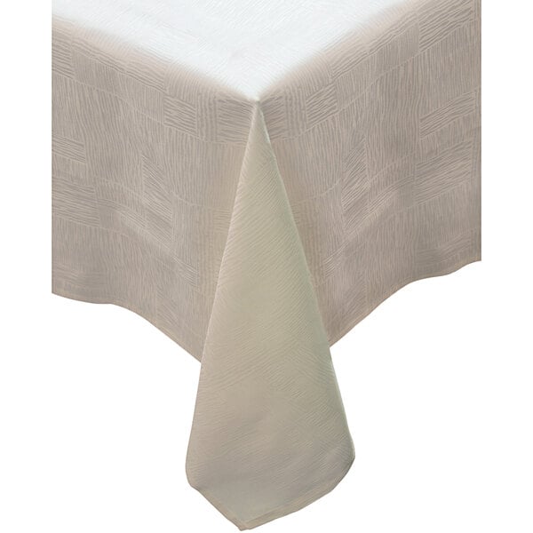 A white Garnier-Thiebaut tablecloth with an ivory border.