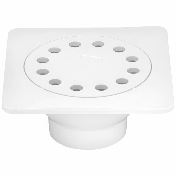 A white square PVC floor drain with holes in it.