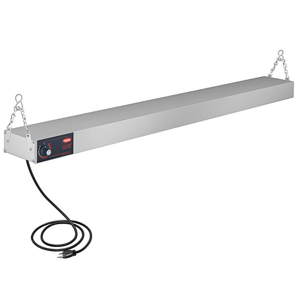 A white rectangular metal shelf with a cord.