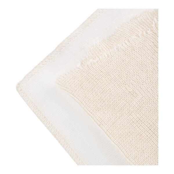 A close-up view of a light-colored, textured fabric with stitched edges, likely cotton.