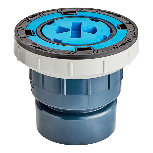 A Zurn PVC cleanout with a square nickel bronze cover and a blue and white plastic pipe with a cross.