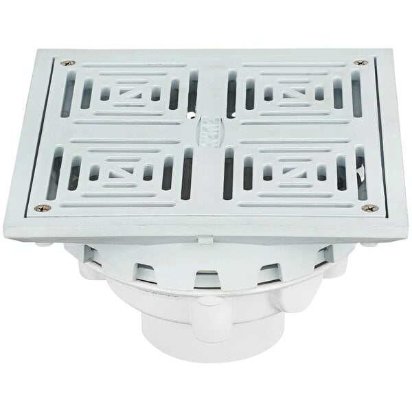 A white square Zurn drain cover with holes.