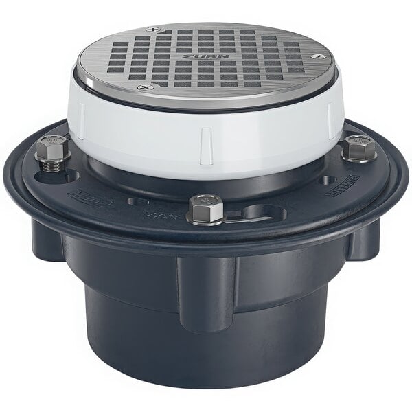 A Zurn floor drain with a white lid and black base and a silver round strainer.