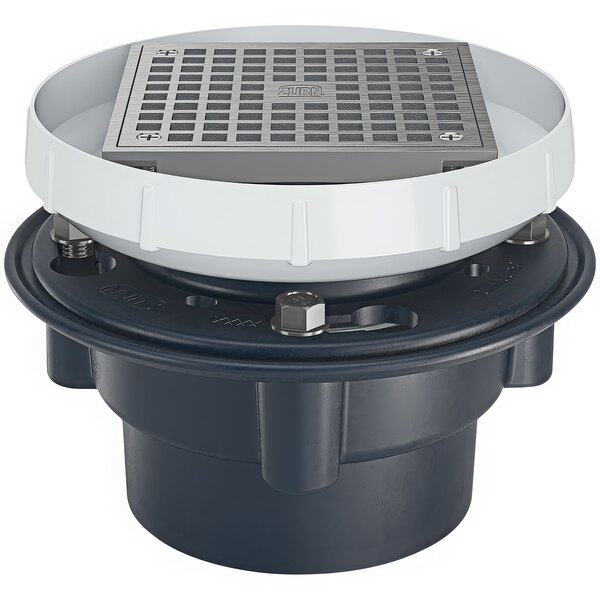 A Zurn floor drain with a square metal strainer with a white circle around it and a black base.