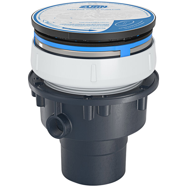 A Zurn floor drain with a round stainless steel head with a blue circle on it.