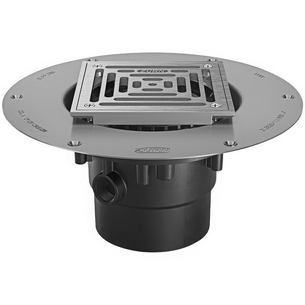A Zurn stainless steel floor drain deck plate with round metal grate.