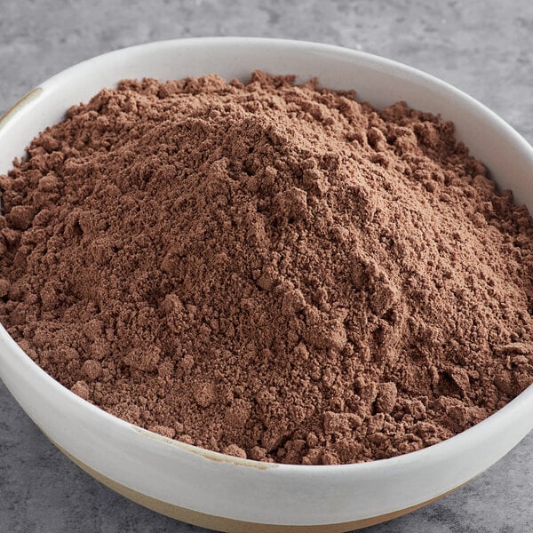 A bowl of brown Pillsbury Bakers' Plus Brownie Mix powder.