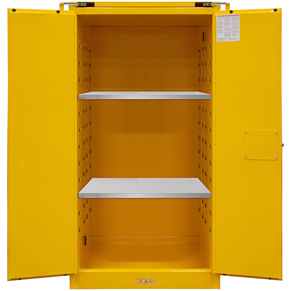 A yellow metal Durham Manufacturing safety cabinet with shelves.