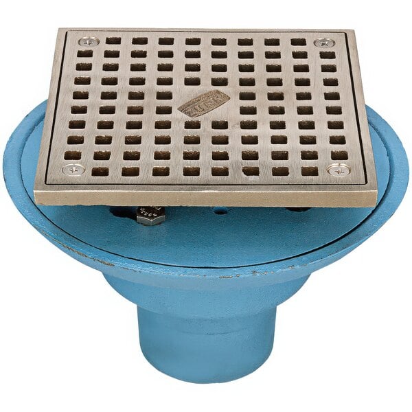 A blue metal Zurn floor drain with a square metal grate with holes.