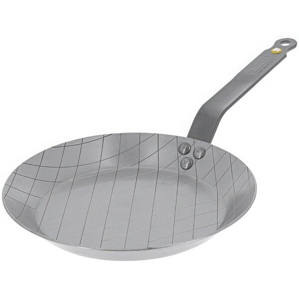 A silver de Buyer carbon steel searing pan with a handle.