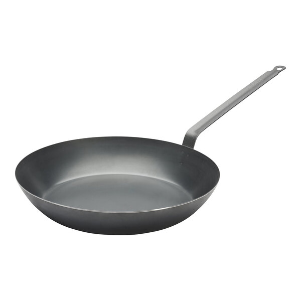 A close-up of a black de Buyer La Lyonnaise carbon steel fry pan with a handle.