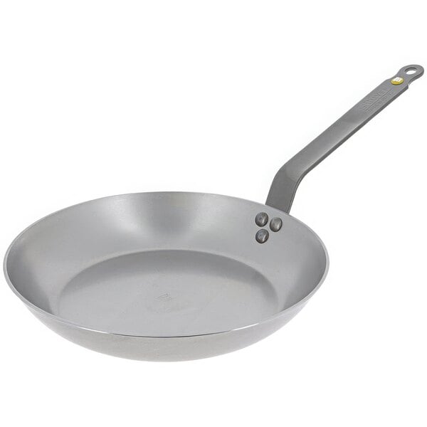 A de Buyer carbon steel frying pan with a silver handle.