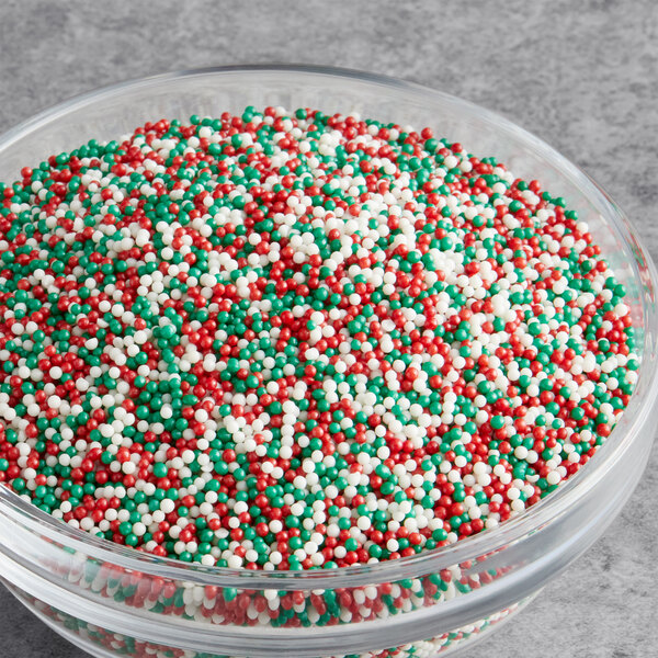 A bowl of Christmas nonpareil mix with red, green, and white candy sprinkles.