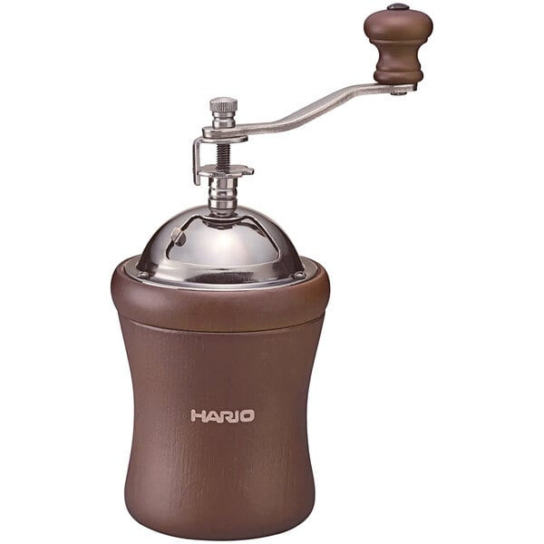 A close-up of a Hario coffee grinder with a wooden handle.