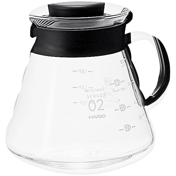 A Hario V60 glass coffee server with a black handle.