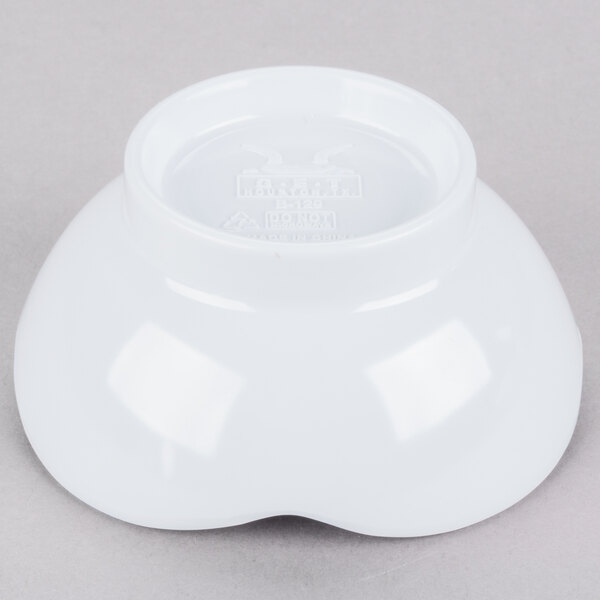 A white melamine scallop shaped bowl.