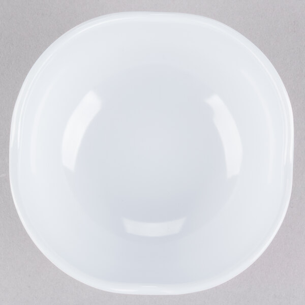 A white scallop shaped melamine bowl.