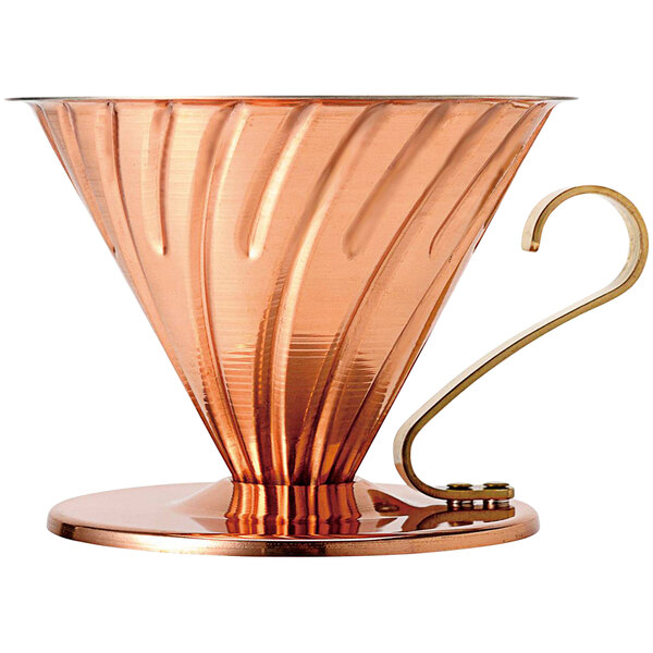 A copper coffee pot with a gold handle.