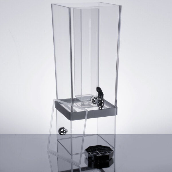 A clear plastic Cal-Mil beverage dispenser with a silver lid and ice chamber.
