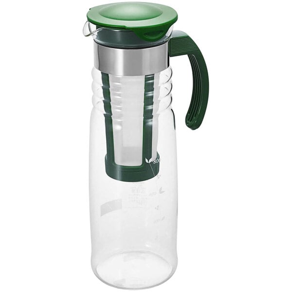 A dark green glass water pitcher with a lid.