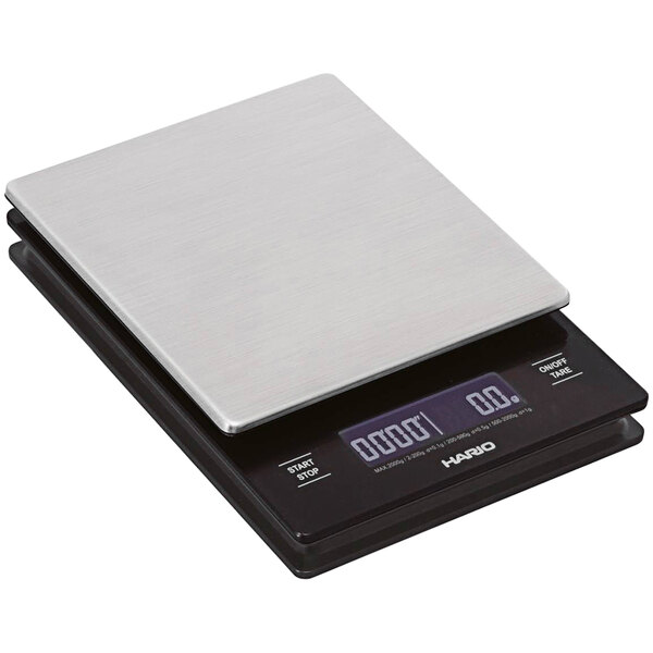 A close-up of a Hario V60 digital scale with a silver surface.