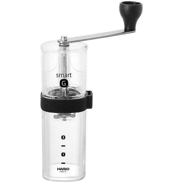 A Hario coffee mill with a clear glass top and black plastic and glass parts.