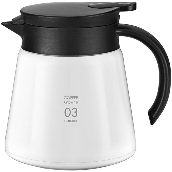 A white coffee server with black lid and handle.