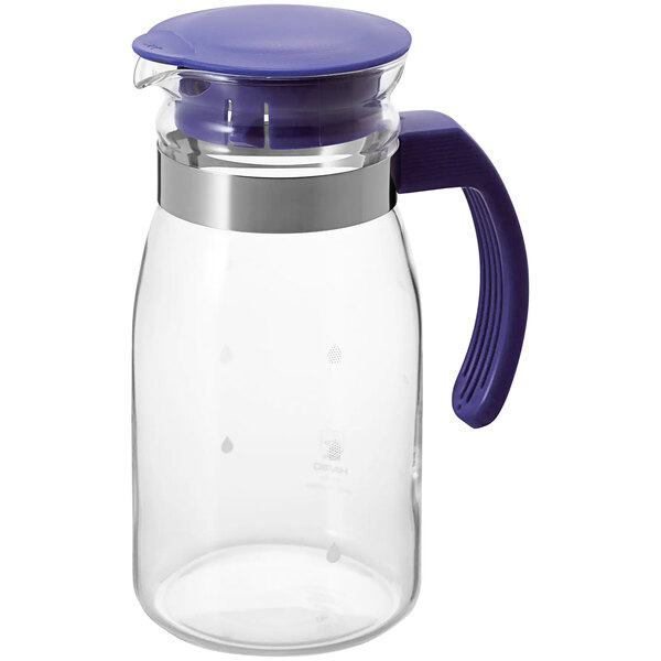 A clear glass pitcher with a blue handle and lid.