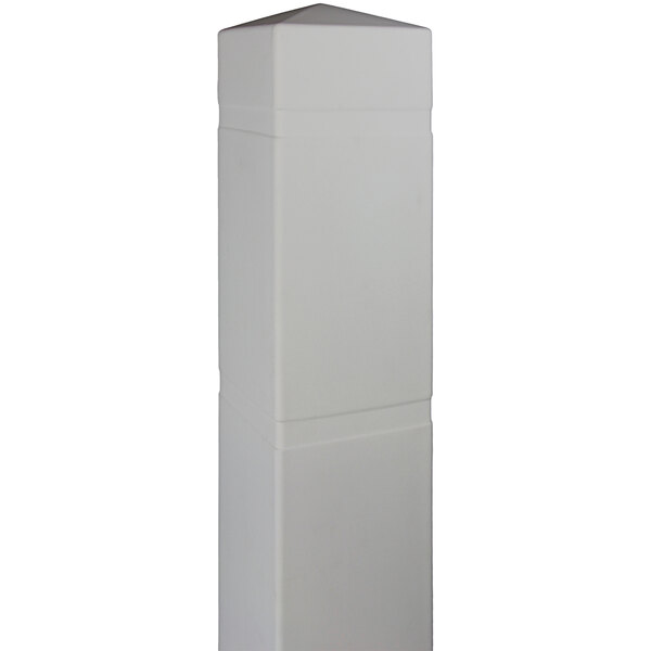 A white rectangular object that covers a square bollard with a pointy top.