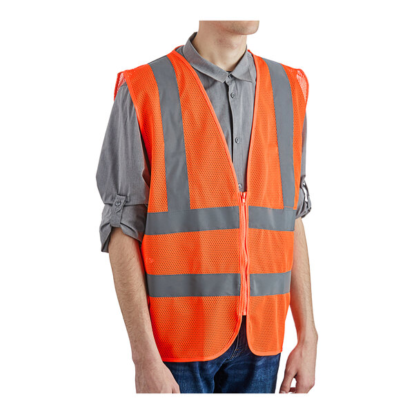 A person wearing a Lavex orange safety vest with reflective stripes.
