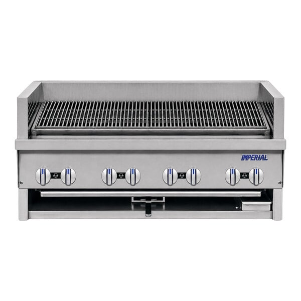 A large stainless steel broiler with eight control knobs and a grill surface, viewed from the front.