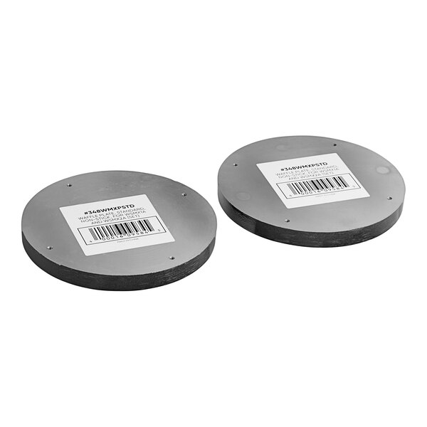 A pair of circular metal discs with bar code labels.