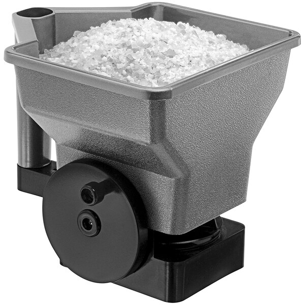 A Suncast handheld crank spreader filled with white salt.