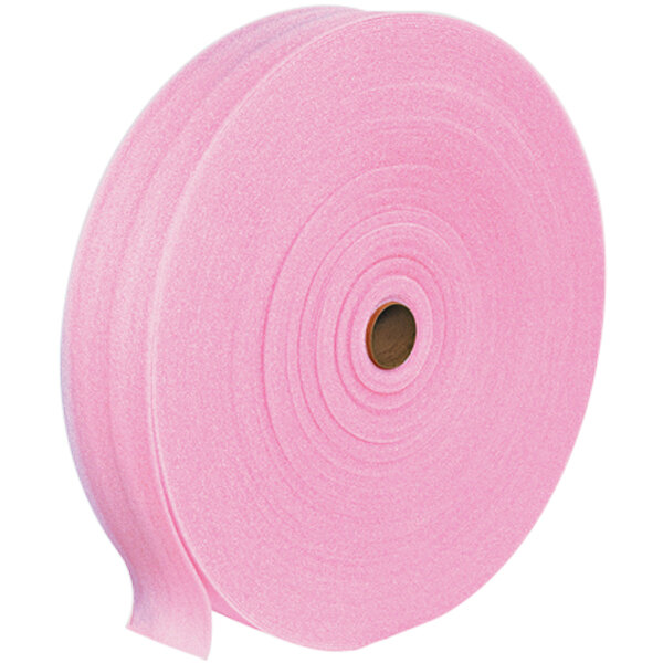 A close-up of a pink roll of foam with a brown circle on it.