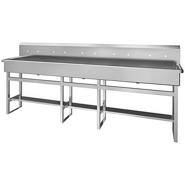 A large stainless steel multi-station floor mounted sink with 5 faucets and 8" centers.