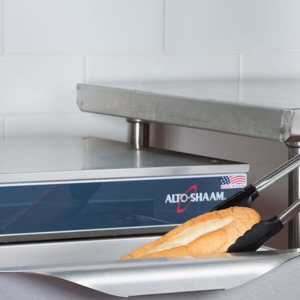 A bread stick in a Alto-Shaam drawer warmer.